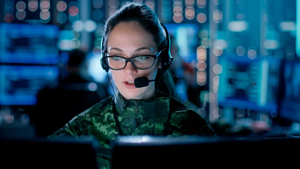 Analyst at screen on headset