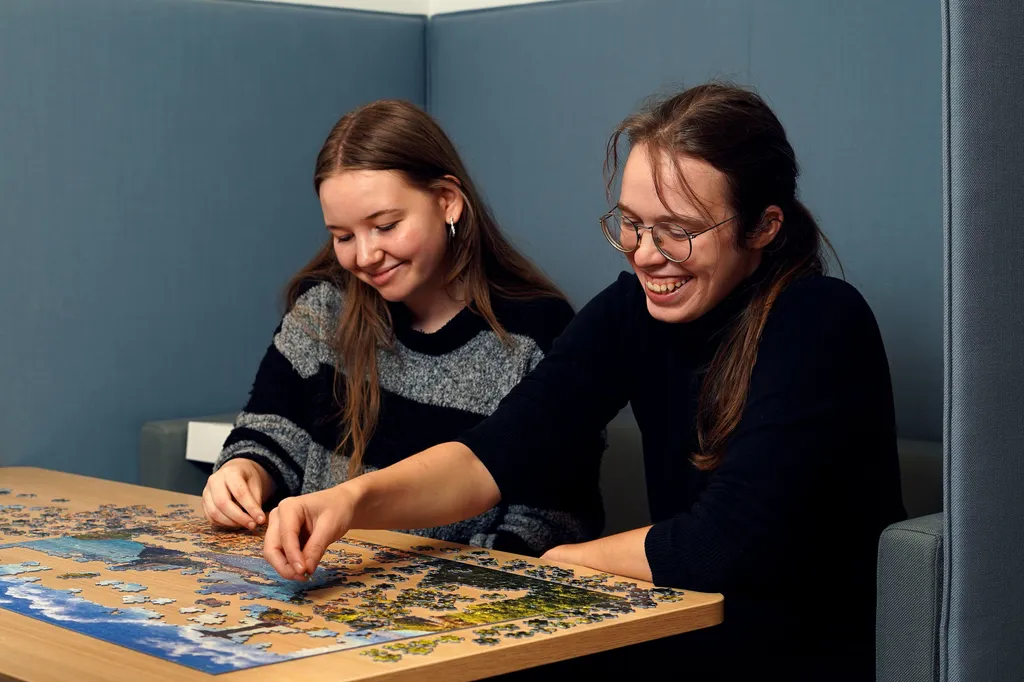 Two women solving a puzzle together